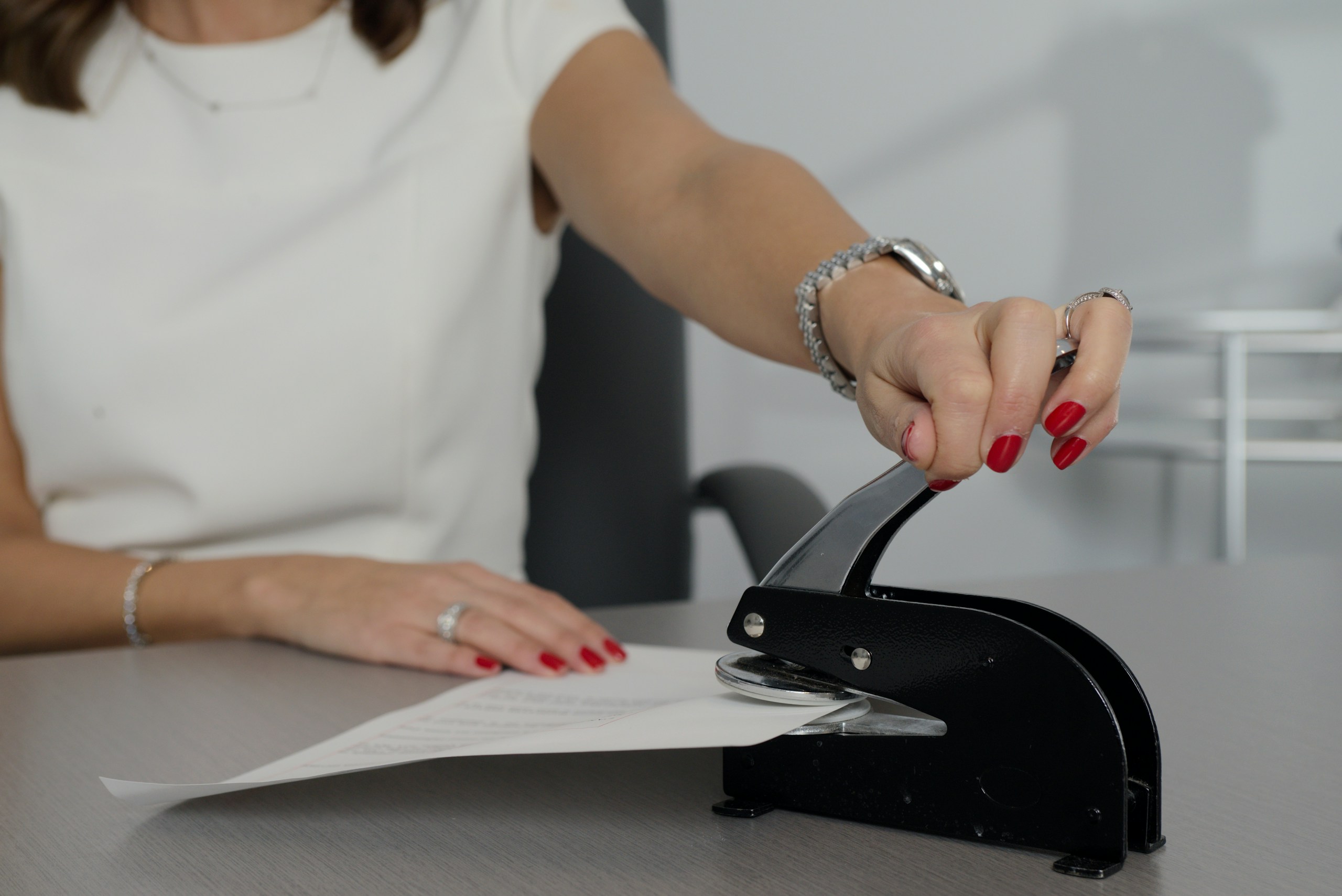 Notary putting a professional seal on a legal document