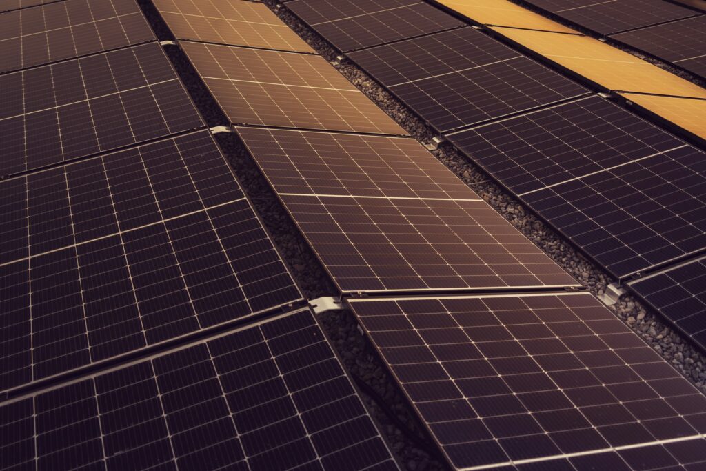 Rows of solar panels on a large commercial rooftop